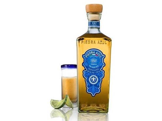"A bottle of Piedra Azul Reposado with a lemon">