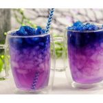 "galaxy cocktail with ice and straws">