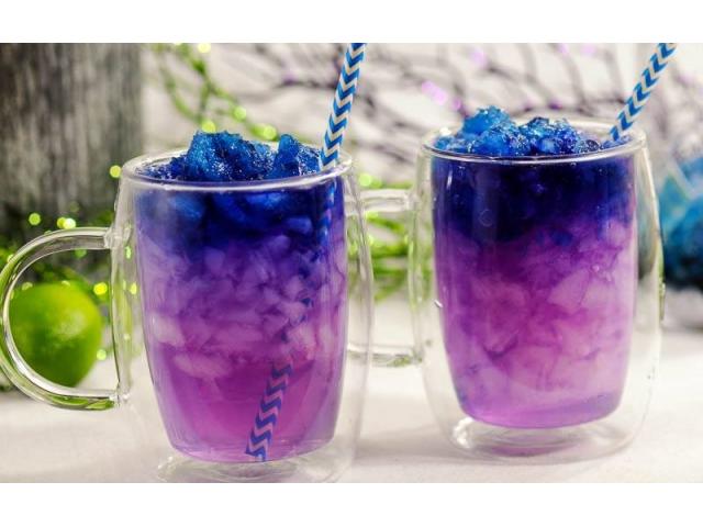 "galaxy cocktail with ice and straws">