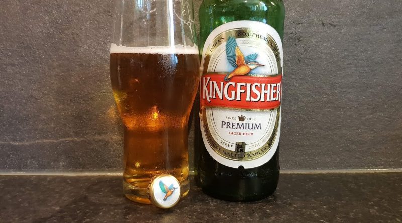"Kingfisher premium lager beer bottle with a glass filled with the beer">
