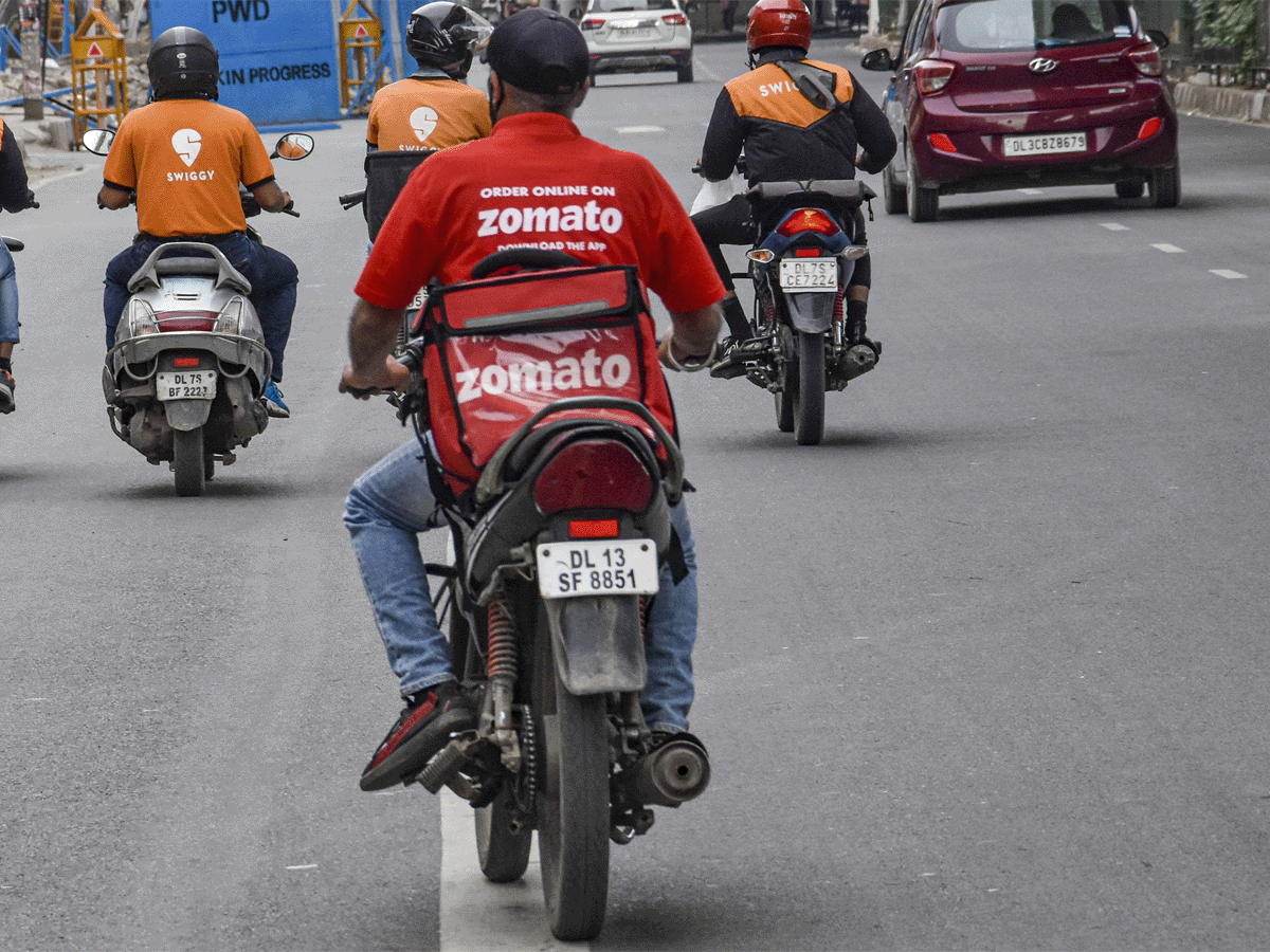 "Zomato and swiggy delivery boys riding">